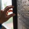 Person repairing a torn flyscreen.